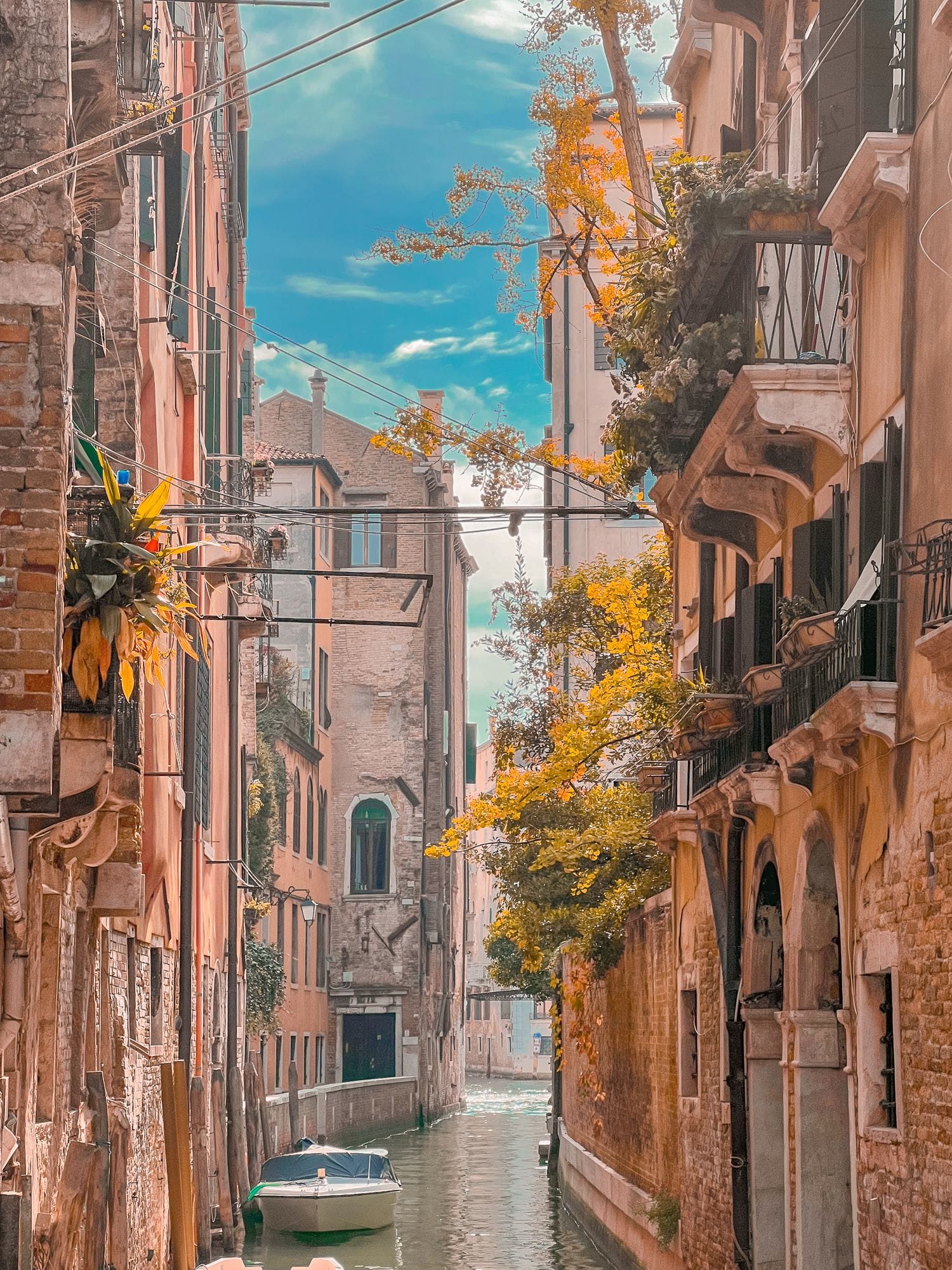 Narrow canal in Venice, Italy — gondolas and weathered facades